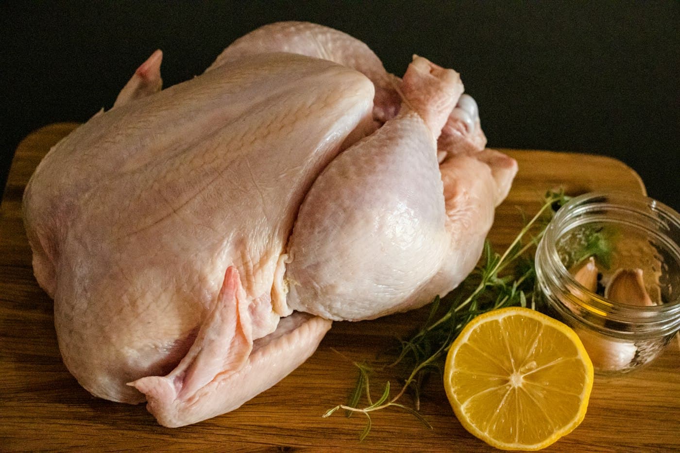 A whole raw chicken prepared for the kitchen